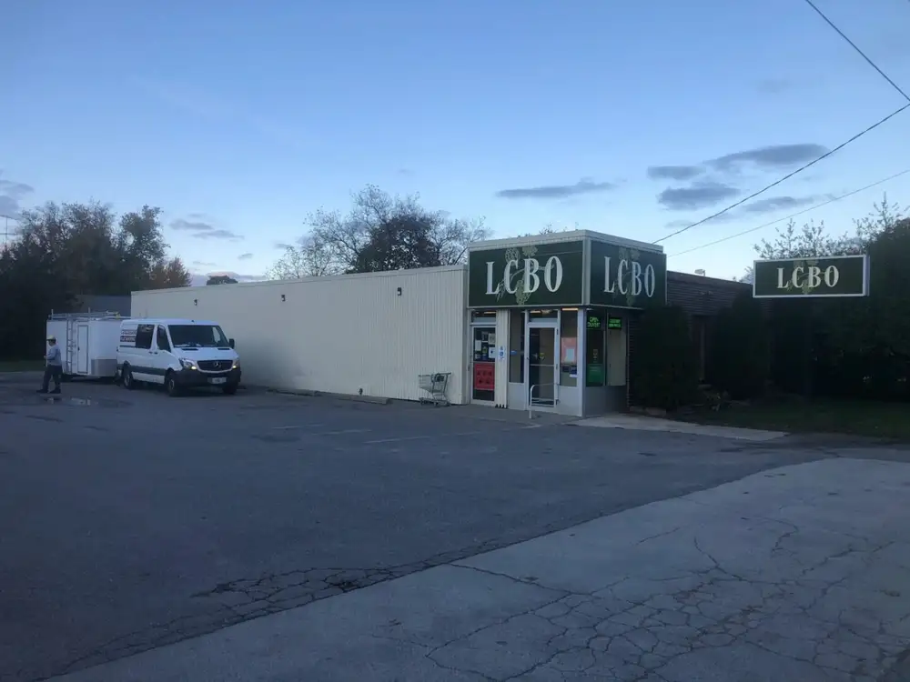 A van parked in front of a building with a sign on it.