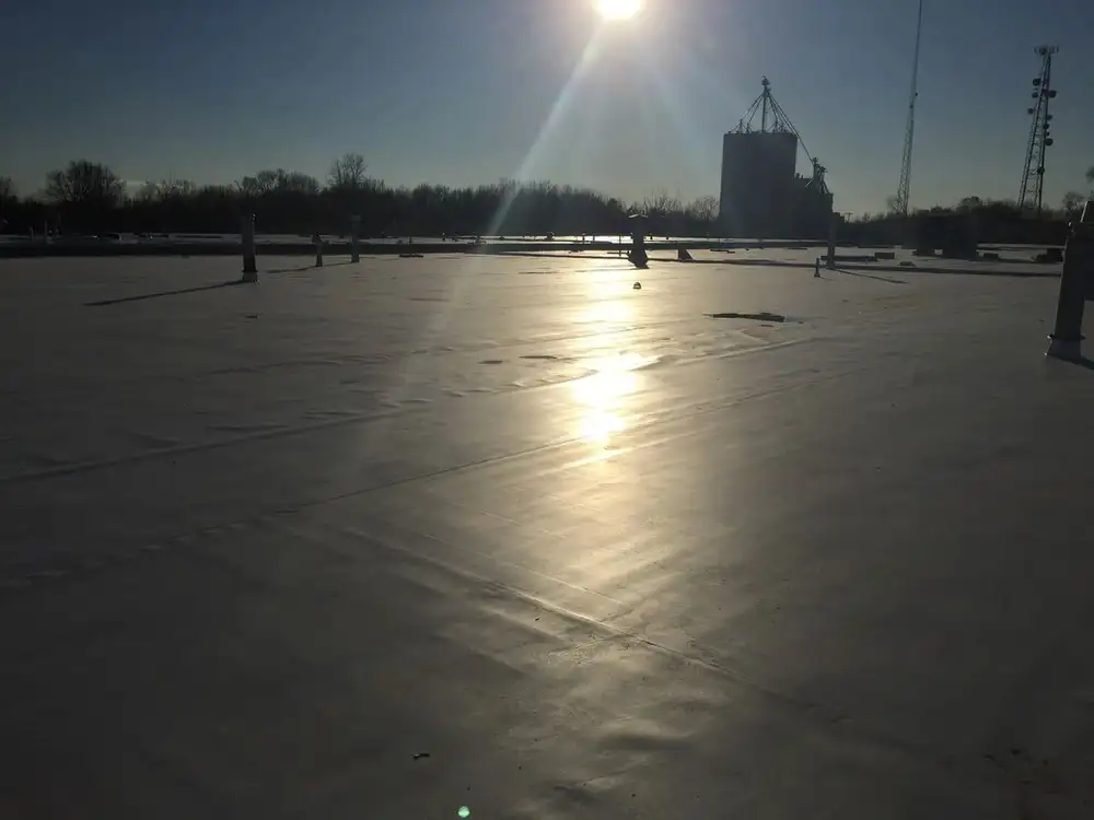 A person is standing on the ice of an open area.