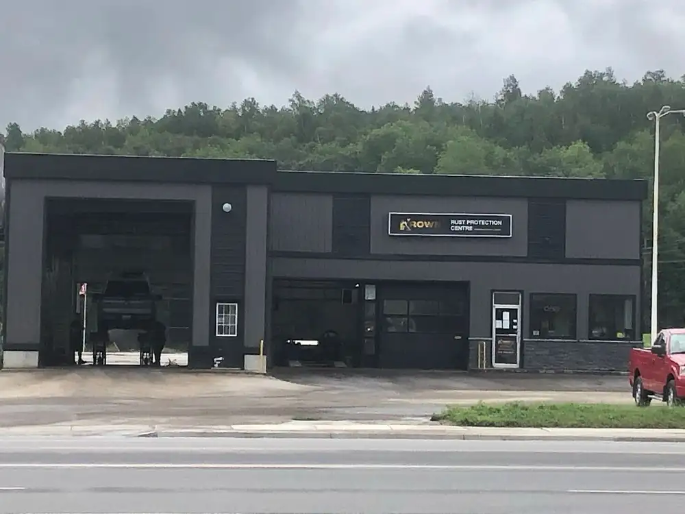 A black building with a large truck in front of it.